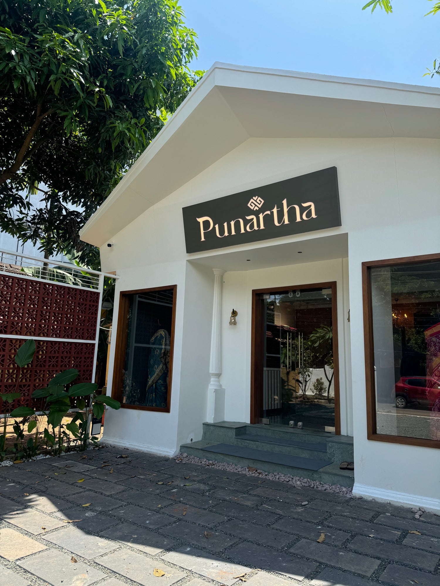 Building entrance with 'Punartha' sign on a clear day