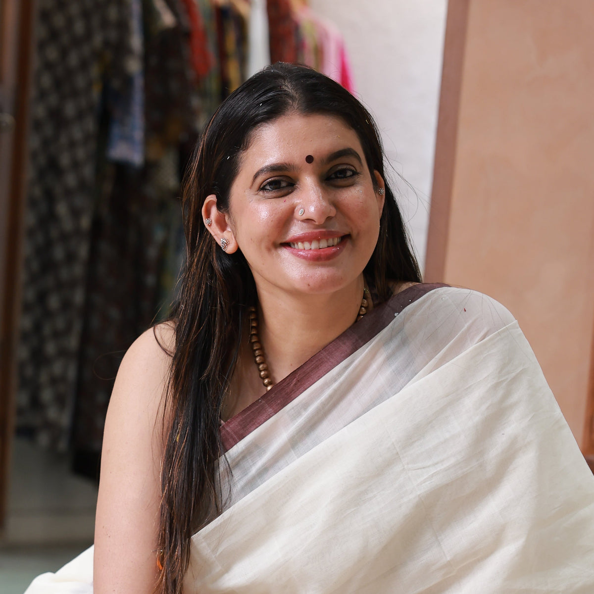 Rekha Sunil, founder of Punartha, wearing a cream saree