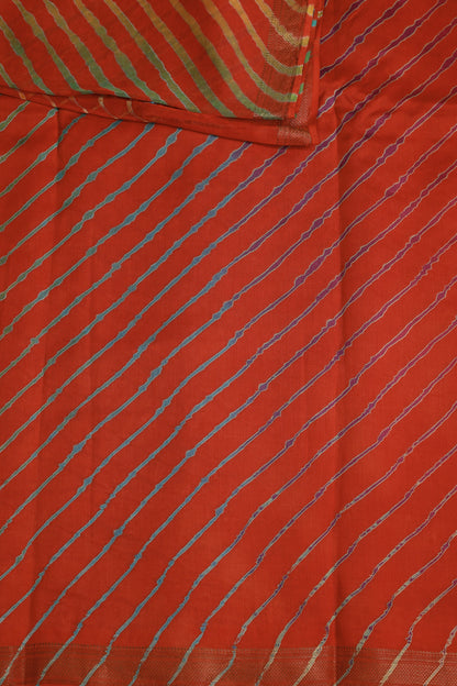 Orange-red saree with multicoloured diagonal Lahariya stripes and a narrow metallic border