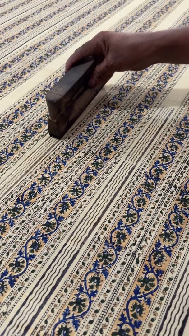 A wooden printing block and detailed pattern on cloth