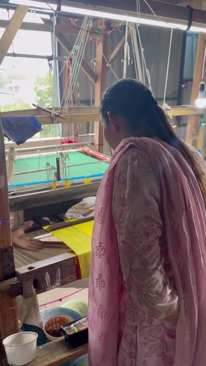 Rekha beside a working handloom