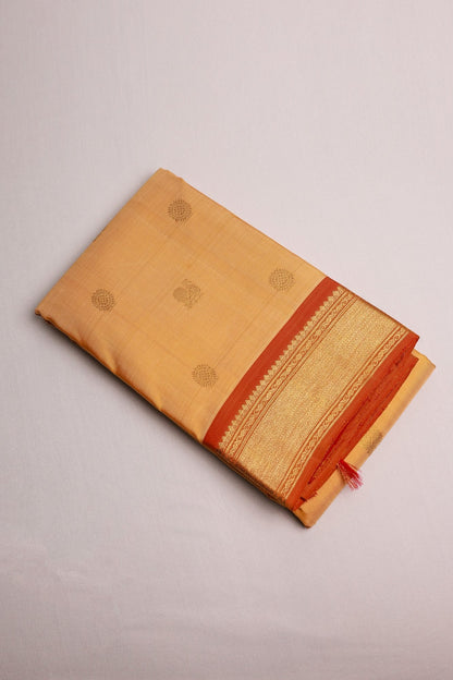 Sandalwood Kanjeevaram Saree with Light Orange Zari Border Mayil Chakram Buttas on Body