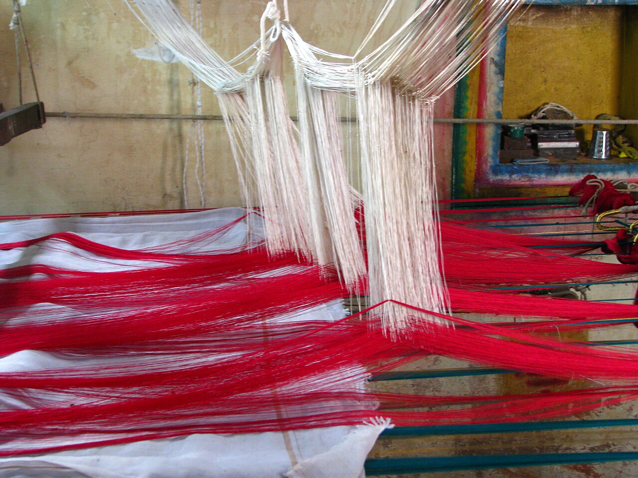 Red silk threads on a handloom in Kanchipuram